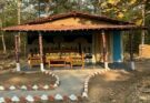 A beautiful traditional mud house surrounded by the lush green forests of Devpur Nature Camp near Barnawapara, Chhattisgarh.