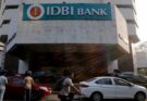 A conceptual business image showing the IDBI Bank logo and a downward financial arrow, representing the lower bids and stalled privatization process.
