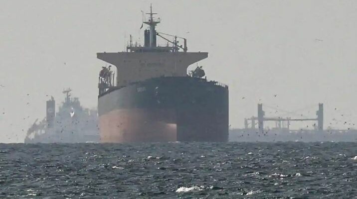 A conceptual image showing an Indian merchant ship with the tricolor flag being safely escorted by naval vessels in the Strait of Hormuz.
