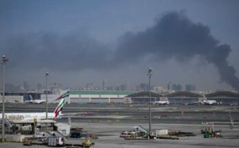 Security forces and emergency vehicles at Dubai International Airport responding to the aftermath of a suspected Iranian drone attack.