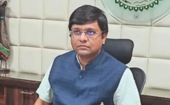 A professional portrait of IAS Dr. Ravi Mittal along with a conceptual backdrop of the Prime Minister Office showcasing his new appointment.