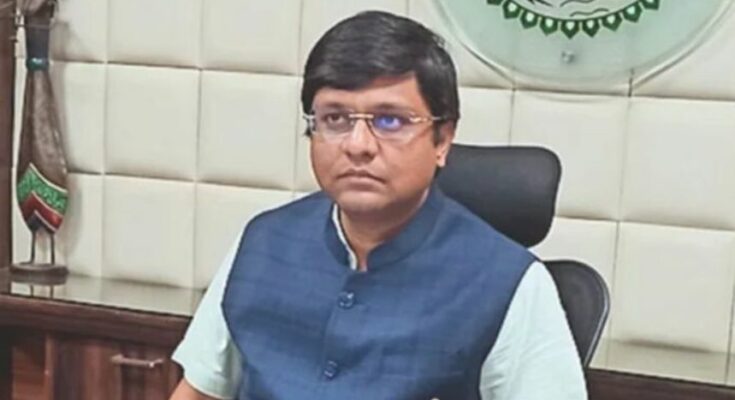 A professional portrait of IAS Dr. Ravi Mittal along with a conceptual backdrop of the Prime Minister Office showcasing his new appointment.