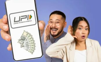 A person holding a smartphone using a UPI payment app like Google Pay or PhonePe.