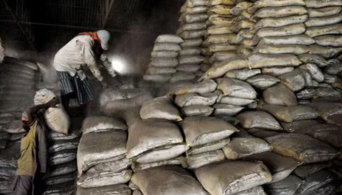 A conceptual image showing stacked cement bags and rising price graphs, highlighting the sudden CG cement price hike and political allegations in Chhattisgarh.
