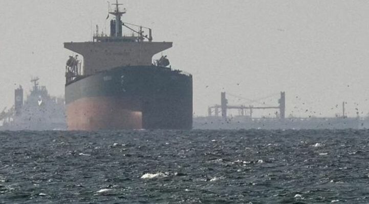 A conceptual image showing a commercial ship on fire in the sea after a drone attack, highlighting the recent Iran-Israel war escalation in the Strait of Hormuz.