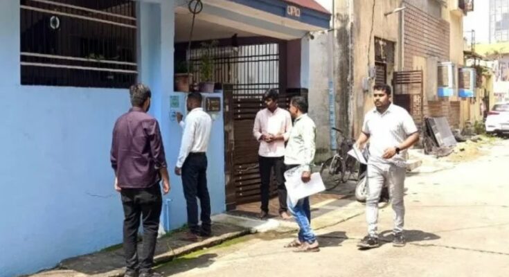 A conceptual image showing a census worker noting details digitally on a tablet outside a house with a fresh census number painted on the wall, highlighting the Raipur Census 2026.